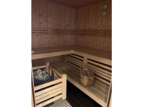 a sauna with wooden walls and wooden shelves at Villa Seebrise Modern retreat in Göhren-Lebbin