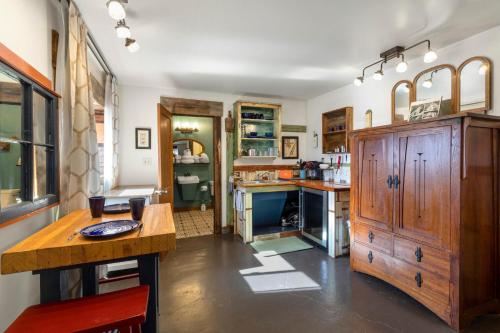 a kitchen with a large wooden cabinet and a counter at Main Street Studio in Creede