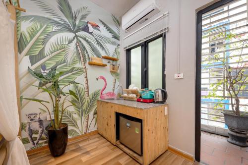 a kitchen with a flamingo mural on the wall at Trinh's House - Hang Vai in Hanoi