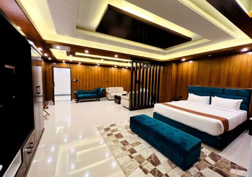 a bedroom with a bed and a living room at Hotel Elite Palace in Comilla