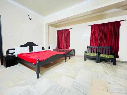 a bedroom with two beds and red curtains at Coorg HillTown Hotel - Madikeri in Madikeri