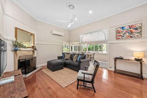 a living room with a couch and a fireplace at Poppy's Place! 4Bed/1Bath/2Car/Views/House ~Bardon in Brisbane