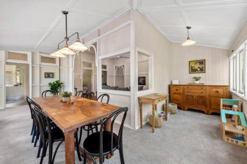 a dining room with a wooden table and chairs at Poppy's Place! 4Bed/1Bath/2Car/Views/House ~Bardon in Brisbane