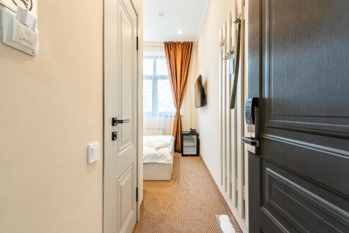 a hallway with a door leading to a bedroom at AYKUN Hotel in Almaty