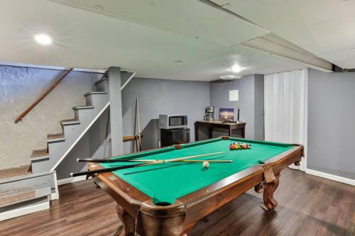 a room with a pool table and a staircase at *Rare* Entire Queen Village House w/ Pool Table in Philadelphia