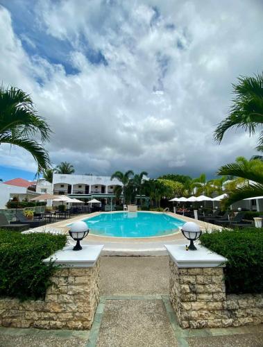 a large swimming pool in a resort with palm trees at Panglao Regents Park Resort in Panglao Island