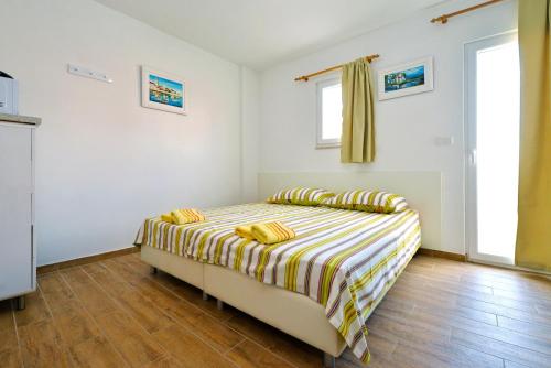 Ένα ή περισσότερα κρεβάτια σε δωμάτιο στο Apartments Goranka 2