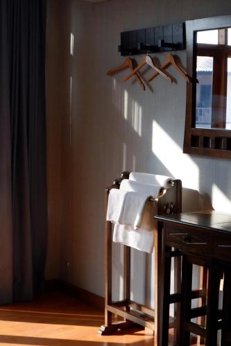 a bathroom with a towel rack and a sink at Delio Boutique Hotel in Udon Thani