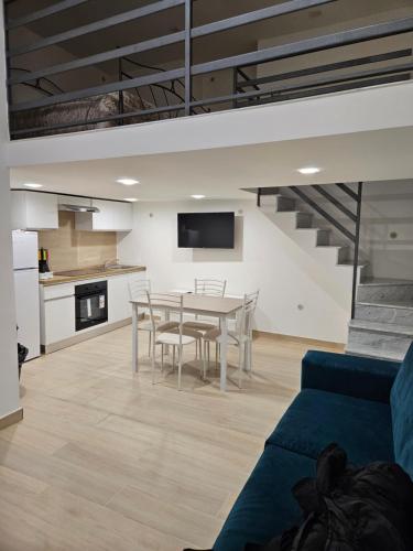 a kitchen and dining room with a table and chairs at Casa savoia dream in Naples