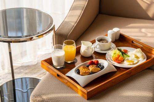 a tray of breakfast foods and drinks on a table at Pullman Foshan Shunde in Shunde