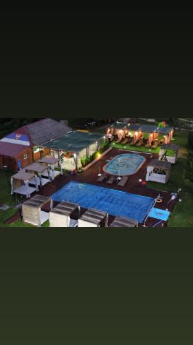 an aerial view of a large swimming pool at night at Brvnara Ruza Rumena in Mionica