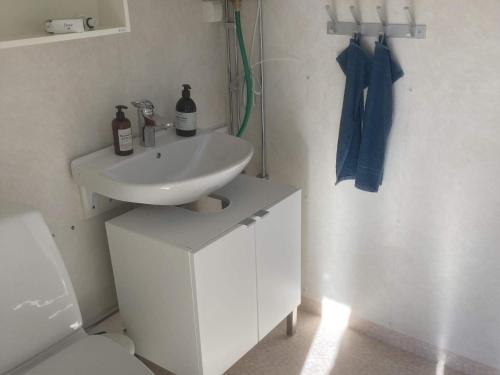 a white bathroom with a sink and a toilet at 4 star holiday home in Kristinehamn-By Traum in Kristinehamn