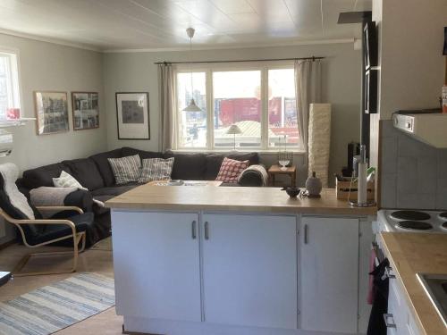 a kitchen and a living room with a couch at 4 star holiday home in Kristinehamn-By Traum in Kristinehamn
