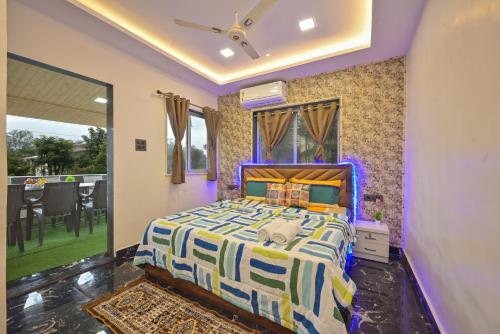 a bedroom with a bed in a room with a window at EMPYREAN STAY ll 3BHK II MARSHAL VILLA II AC II BIG POOL ll LUXURY II in Lonavala