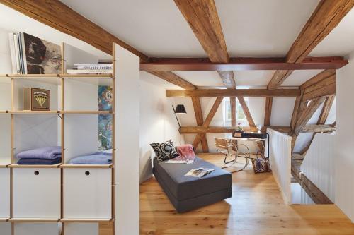 a living room with white cabinets and a couch at Engelwirt Hotel & Apartments in Berching