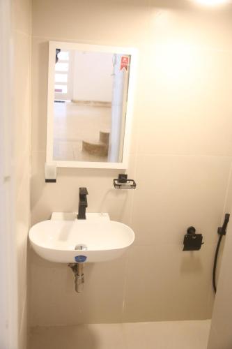 a white sink in a bathroom with a mirror at Mountain View Holidays in Colombo