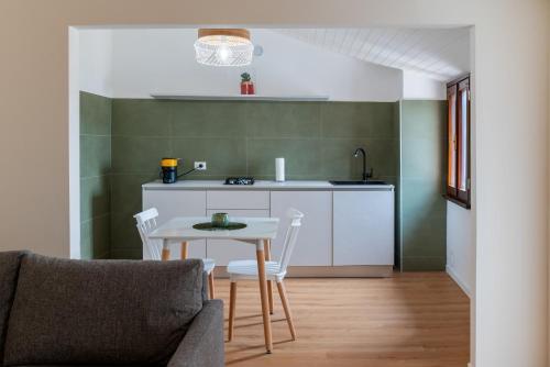 a small kitchen with a table and chairs in a room at Ca' Marinaressa in Portogruaro