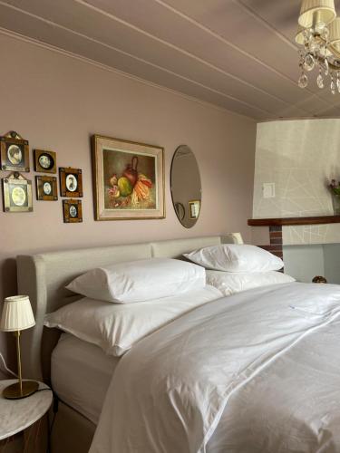 a bedroom with a large bed with white sheets at Sete Fontes - Agarone Holiday Nest in Agarone
