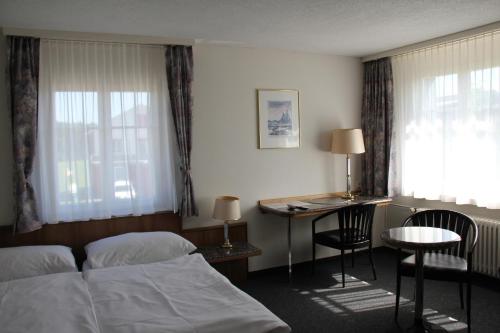 En eller flere senge i et værelse på Hotel Linde