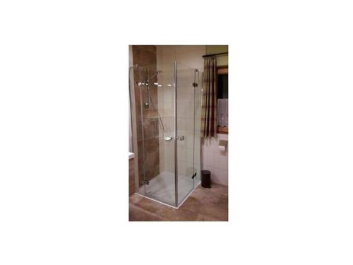 a glass shower stall in a bathroom at Saerbeck mountain hut in Heiligenblut