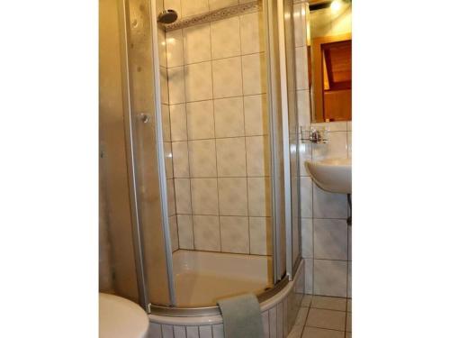 a bathroom with a shower and a toilet and a sink at Holiday apartment Bergstille in Längenfeld