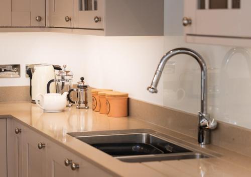 a kitchen counter with a sink in a kitchen at Ravenswell in Dartmouth