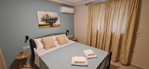 a bedroom with a bed with two towels on it at M&S Apartments Athens in Athens