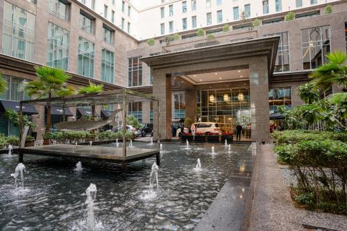 a building with a fountain in the middle of a courtyard at Ritz Carlton DIFC Downtown Dubai in Dubai