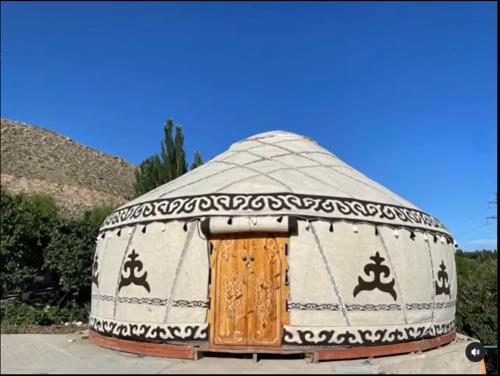 a yurt with a door in the middle at Eagle House in Bosteri