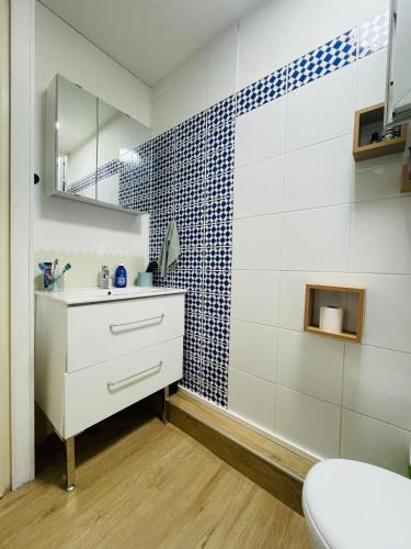 une salle de bain avec un lavabo blanc et un miroir dans l'établissement Welcome to Lacanau, à Lacanau