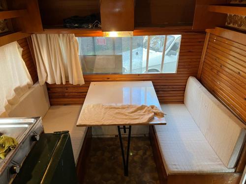 a small kitchen with a table in a small room at Caravan camp in Erdemli