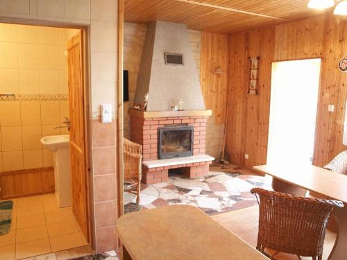 a living room with a fireplace in a room at Ferienwohnung mit Garten - b57084 in Kopalino