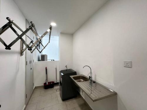 a bathroom with a sink in a white room at Bora Residences by Antlerzone in Johor Bahru