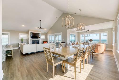 a dining room and living room with a table and chairs at Dune it Wright at Carolina Shores in Nags Head