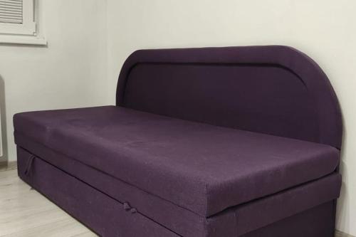 a purple ottoman sitting in a room at Nádherný byt v centre mesta in Levice