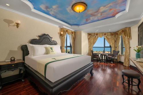 a bedroom with a bed with a painting on the ceiling at V-Hotel in Da Nang