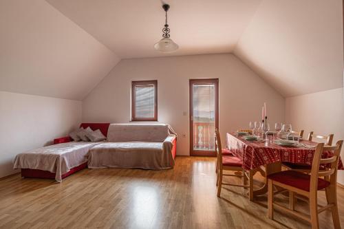 a bedroom with a bed and a table and a dining room at Vineyard Cottage Luštek - Happy Rentals in Novo Mesto