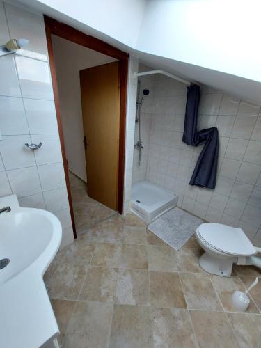a bathroom with a toilet and a sink at Apartmani Romana in Punat