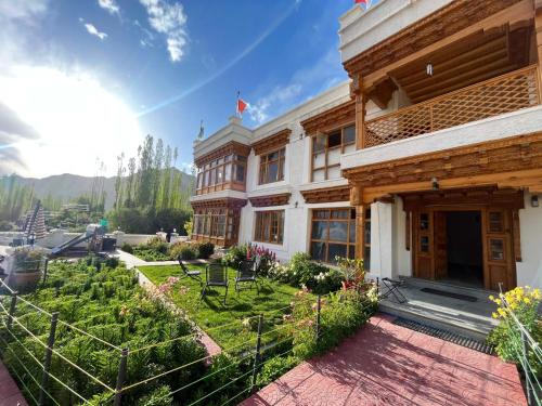 a house with a garden in front of it at Namra Villa in Leh