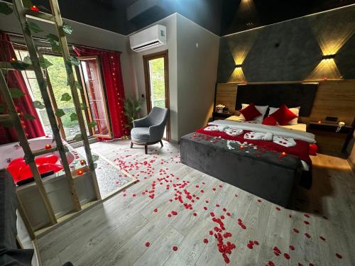a bedroom with a bed with red rose petals on the floor at Puğari Otel in Ardeşen