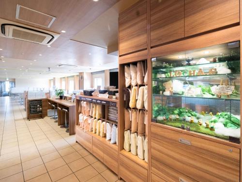 a restaurant with a cafeteria with a food counter at Super Hotel Tozai line Ichikawa Myoden Ekimae in Ichikawa