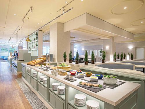 a kitchen with a buffet of food on a counter at Oriental Hotel Tokyo Bay in Urayasu