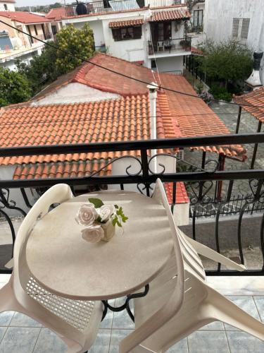 a table and chairs with flowers on a balcony at Pansion Angela in Skiathos Town