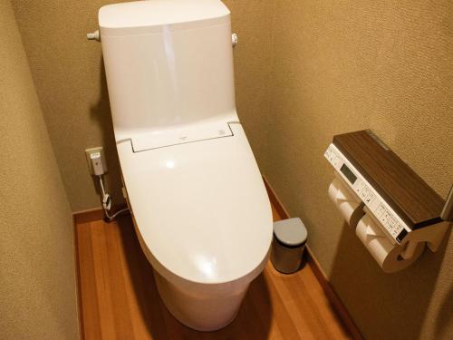 a bathroom with a white toilet in a stall at Keiryuso Siorie in Matsumoto