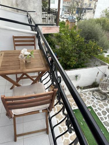 a wooden table and chairs on a balcony at Pansion Angela in Skiathos Town