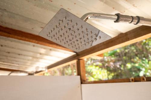a grater on top of a refrigerator next to a window at Long Beach Camp in Perhentian Island