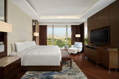 a hotel room with a bed and a television at JW Marriott Hotel Hanoi in Hanoi