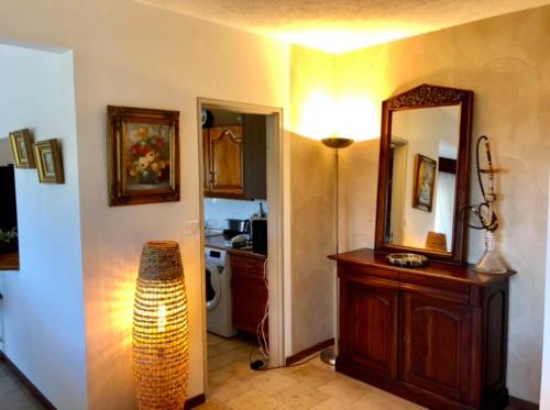 a room with a bathroom with a mirror and a sink at Poerava Tahiti in Papeete