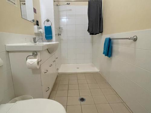 a bathroom with a toilet and a sink and a shower at North Gregory Hotel in Winton