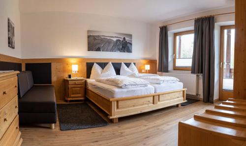 a bedroom with a large bed in a room at Schoenangerhof in Seefeld in Tirol